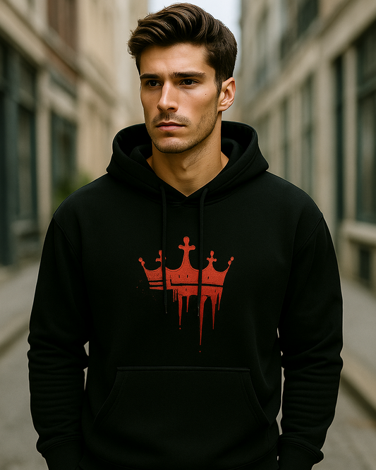 Man wearing a black hoodie with a red bloody crown logo inspired from the movie King in an urban setting.