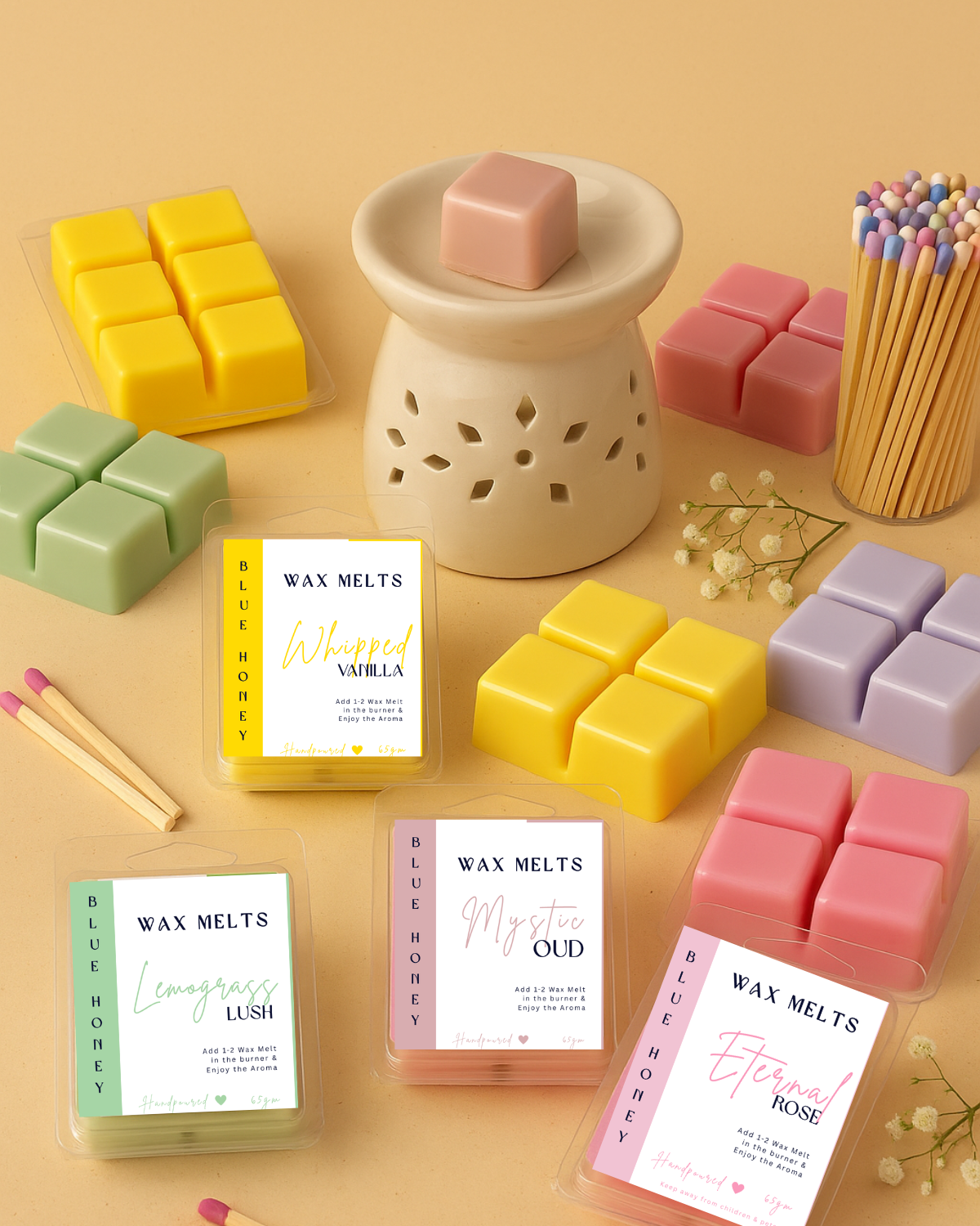 wax melts in rose, oud, lemongrass, vanilla placed with a ceramic diffuser with baby's breath and matchsticks
