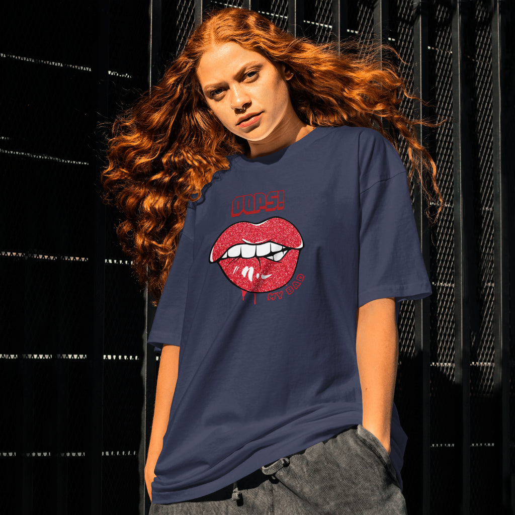 A female model standing wearing 'Oops My Bad' graphic oversized tshirt in navy blue