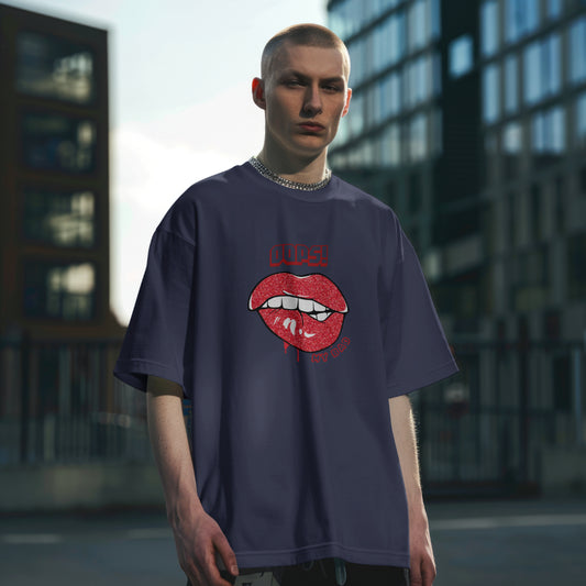 A male model standing straight wearing 'Oops My Bad' graphic oversized tshirt in navy blue