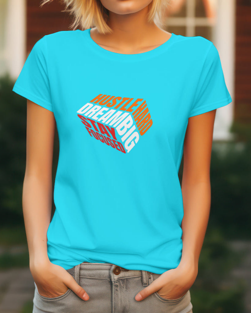 a female model standing with her hands in her pockets wearing a Hustle Hard Dream Big Stay Focused Tshirt in Sky Blue color