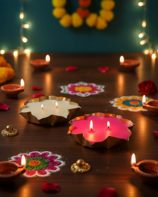 Decorative lotus urli candles and rangoli patterns on a wooden surface with blurred lights in the background.