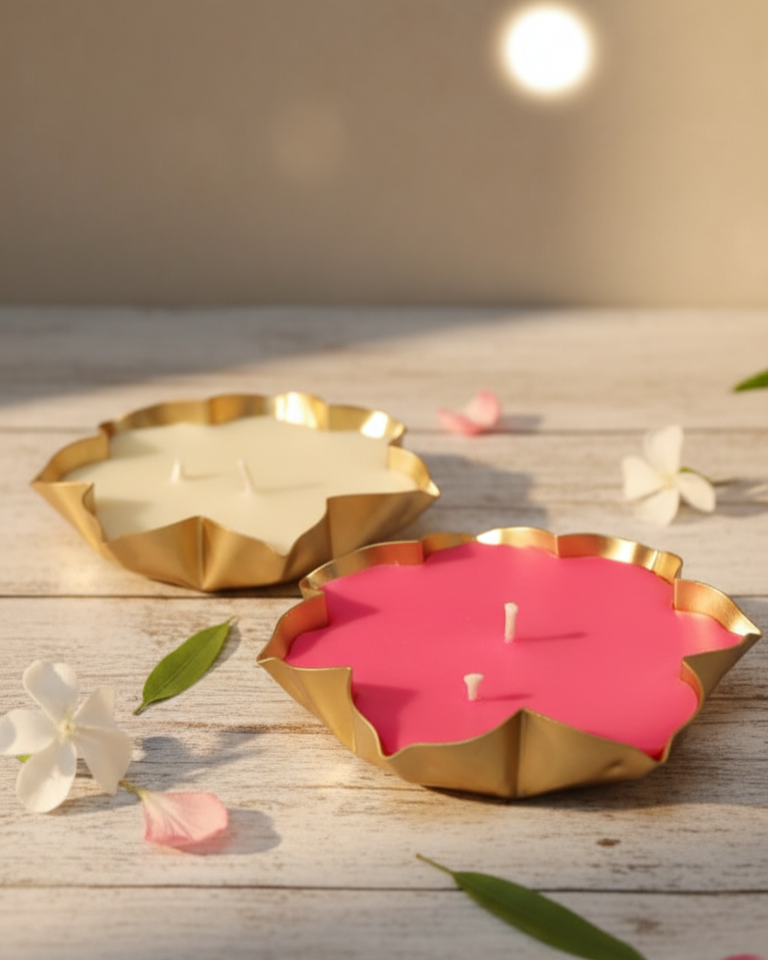 Two Lotus Urli candles on a wooden surface.
