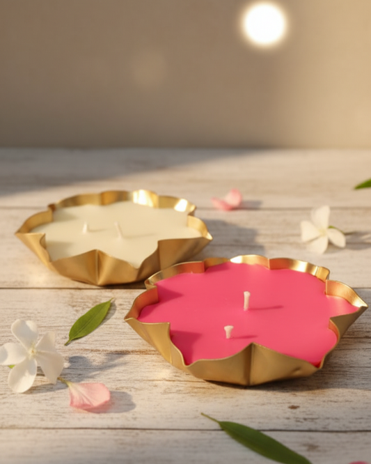 Two Lotus Urli candles on a wooden surface.