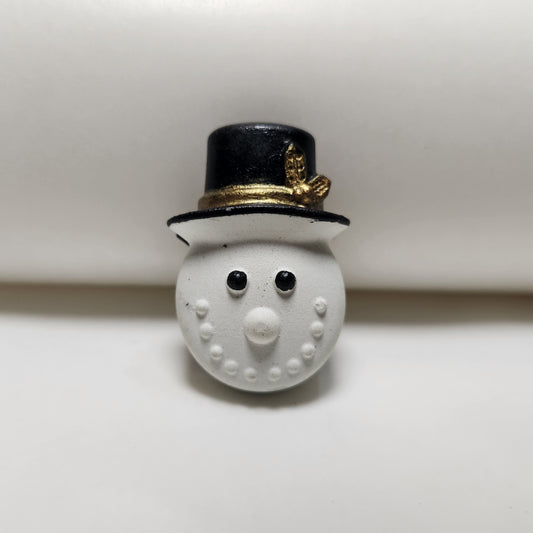 Hand-painted miniature cement snowman fridge magnet with a black top hat, perfect for Christmas and holiday decor.