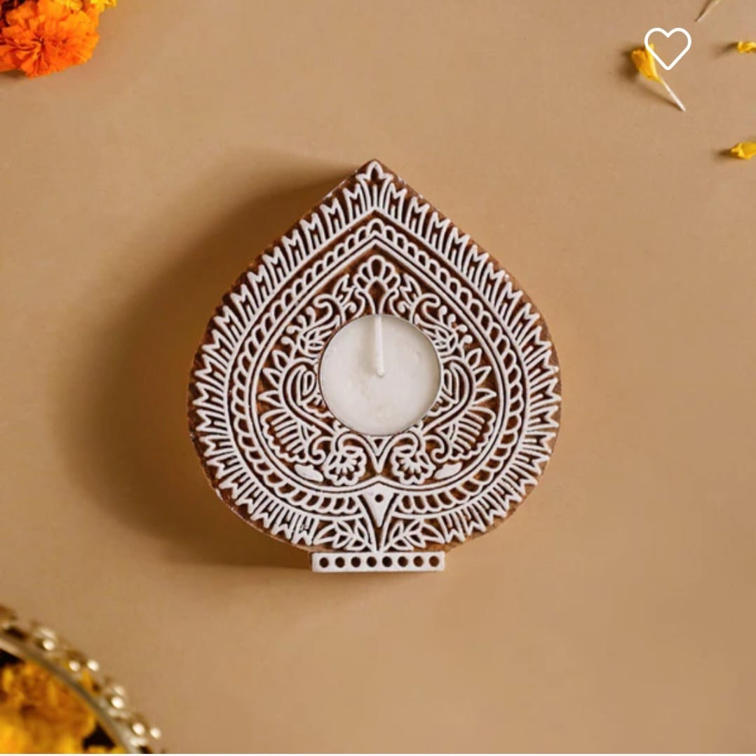 Decorative wooden tealight candle holder with intricate patterns on a beige background