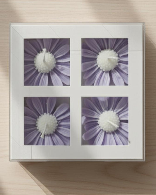 Framed artwork with four purple floral designs on a wooden surface