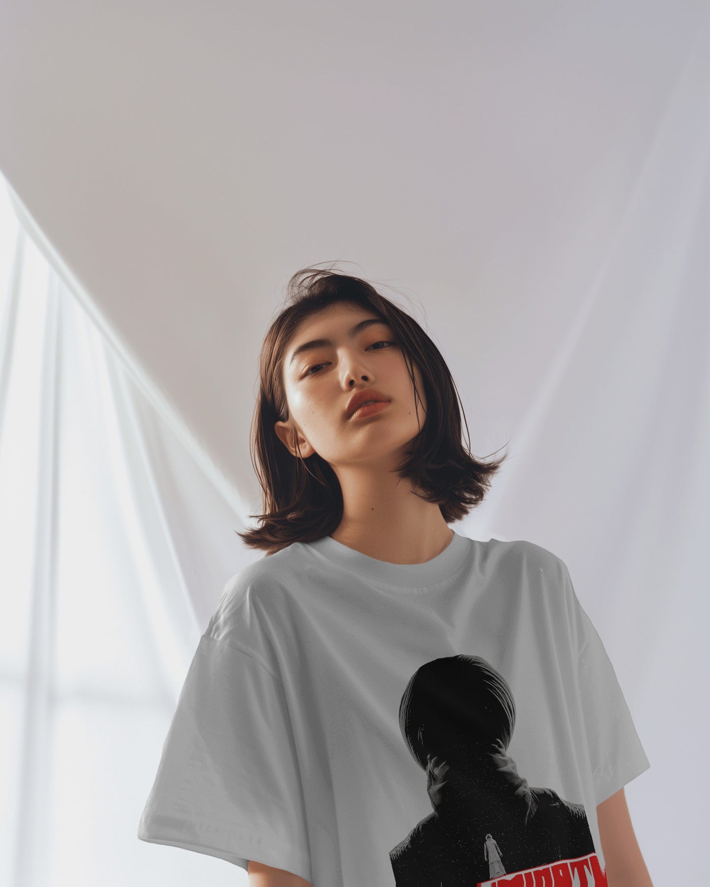 an Asian female model wearing an Oversized Diljit Dosanjh "Diluminati" T-Shirt white