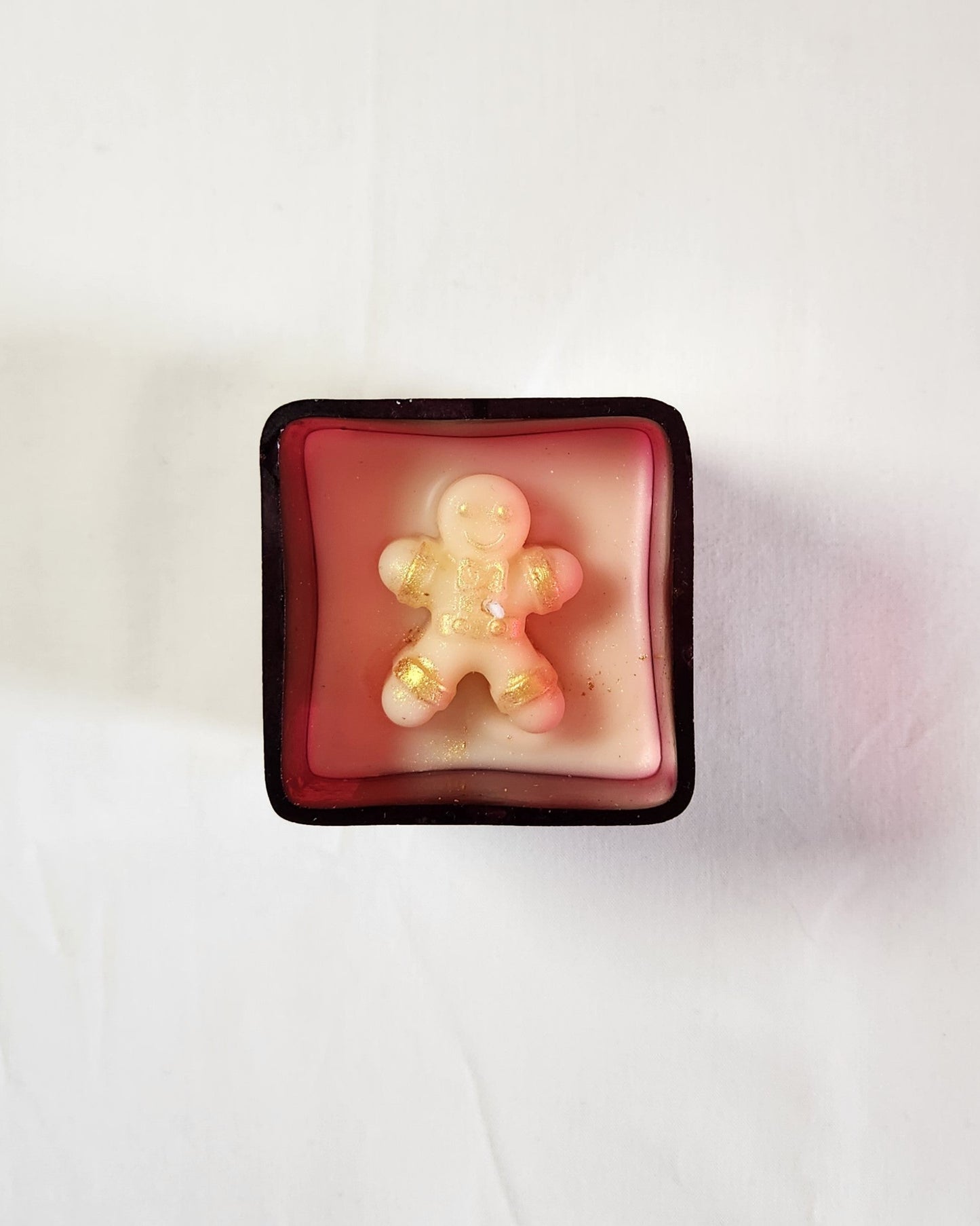 candle with 2d gingerbread candle inside a red glass jar