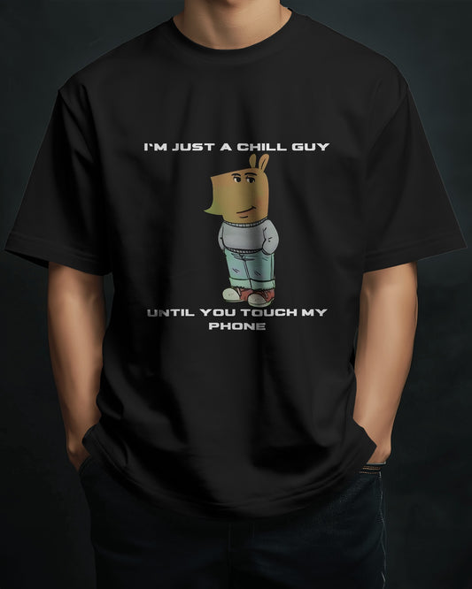 a male model standing with his hands in his pockets wearing a black "I’m Just a Chill Guy… Until You Touch My Phone" tshirt