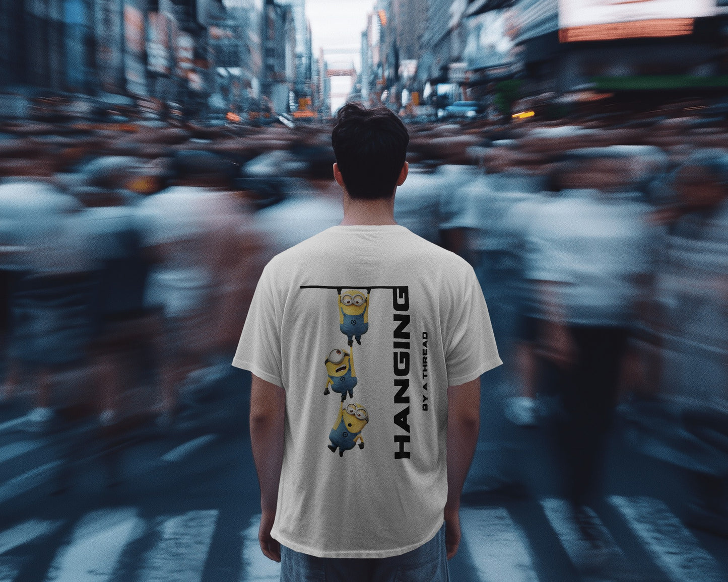 back view of a male model standing in crowd wearing an oversized white minions tshirt