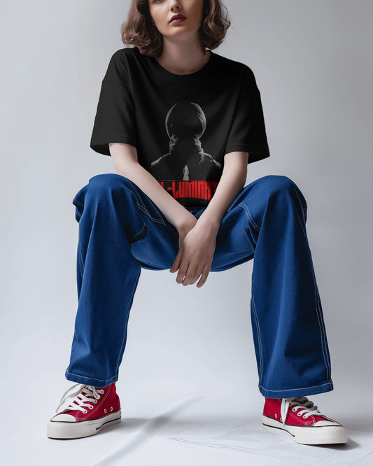 an Asian female model sitting wearing an Oversized Diljit Dosanjh "Diluminati" T-Shirt black