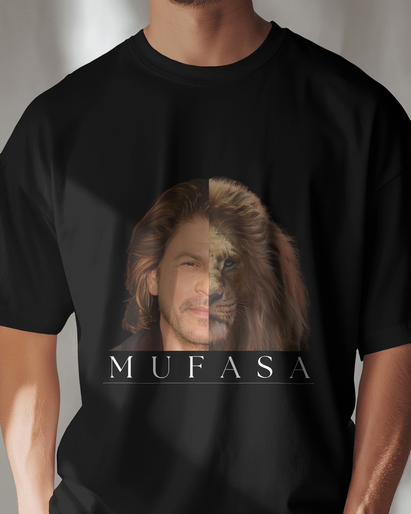 an Indian male model wearing a black classic half sleeve round neck SRK-Mufasa graphic tshirt.
