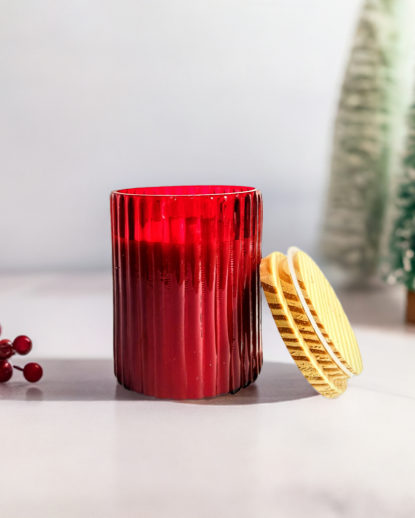 Ruby Glow scented ribbed glass jar candle with lid.