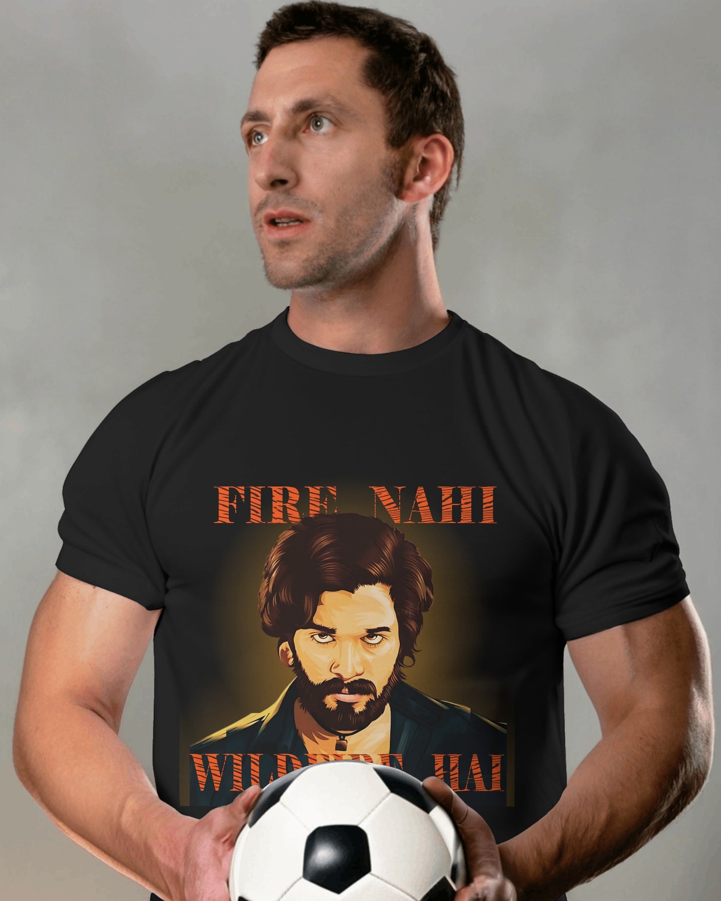 an american model holding a football in hand wearing Fire Nahi Wildfire Hai 'Pushpa 2' T-shirt black
