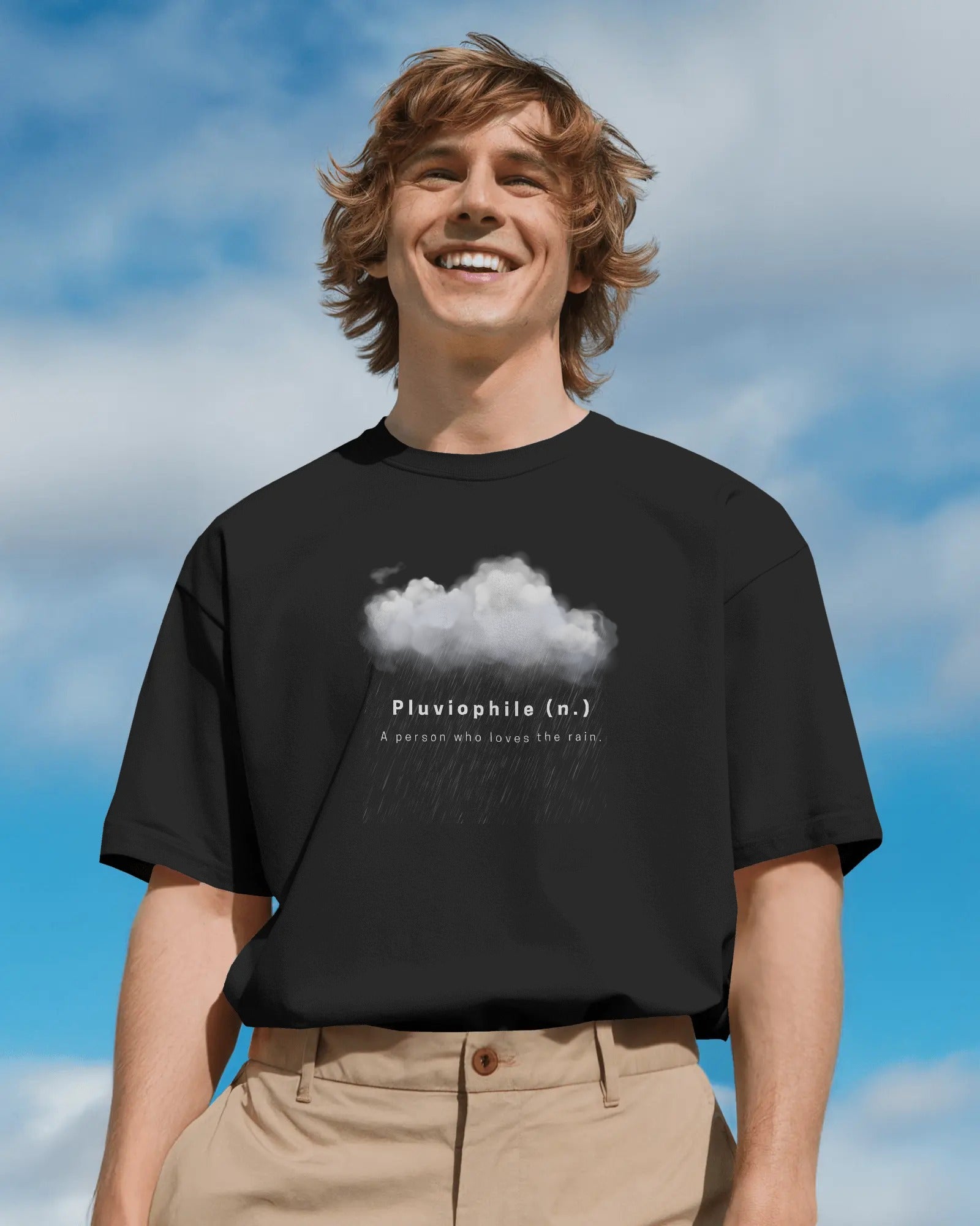 a white male model standing with a smile on his face wearing an oversized black Pluviophile tshit