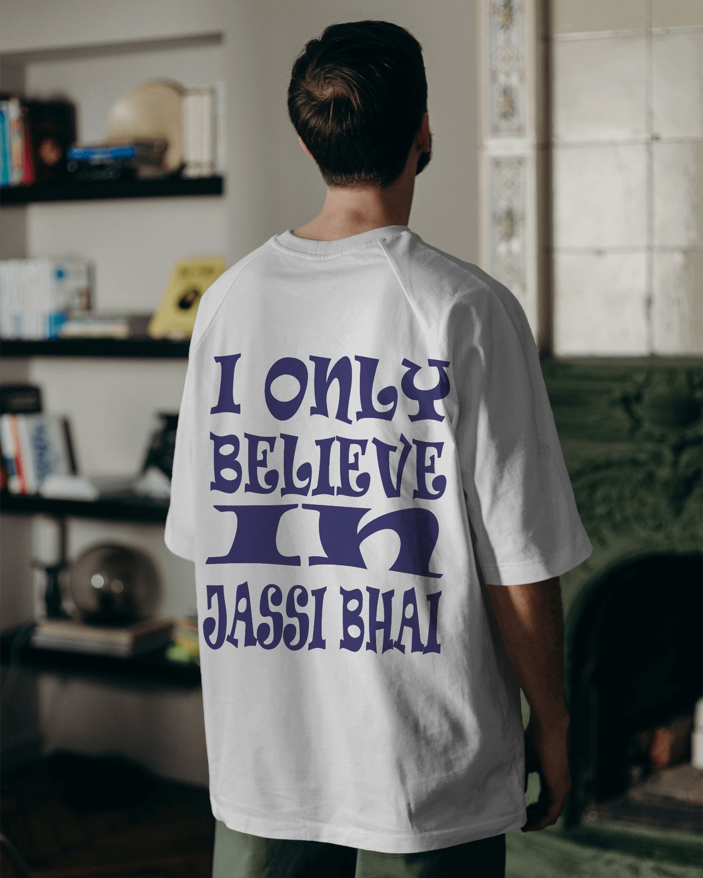 Back view of a male model wearing I only Believe in Jassi Bhai Oversized Tshirt white