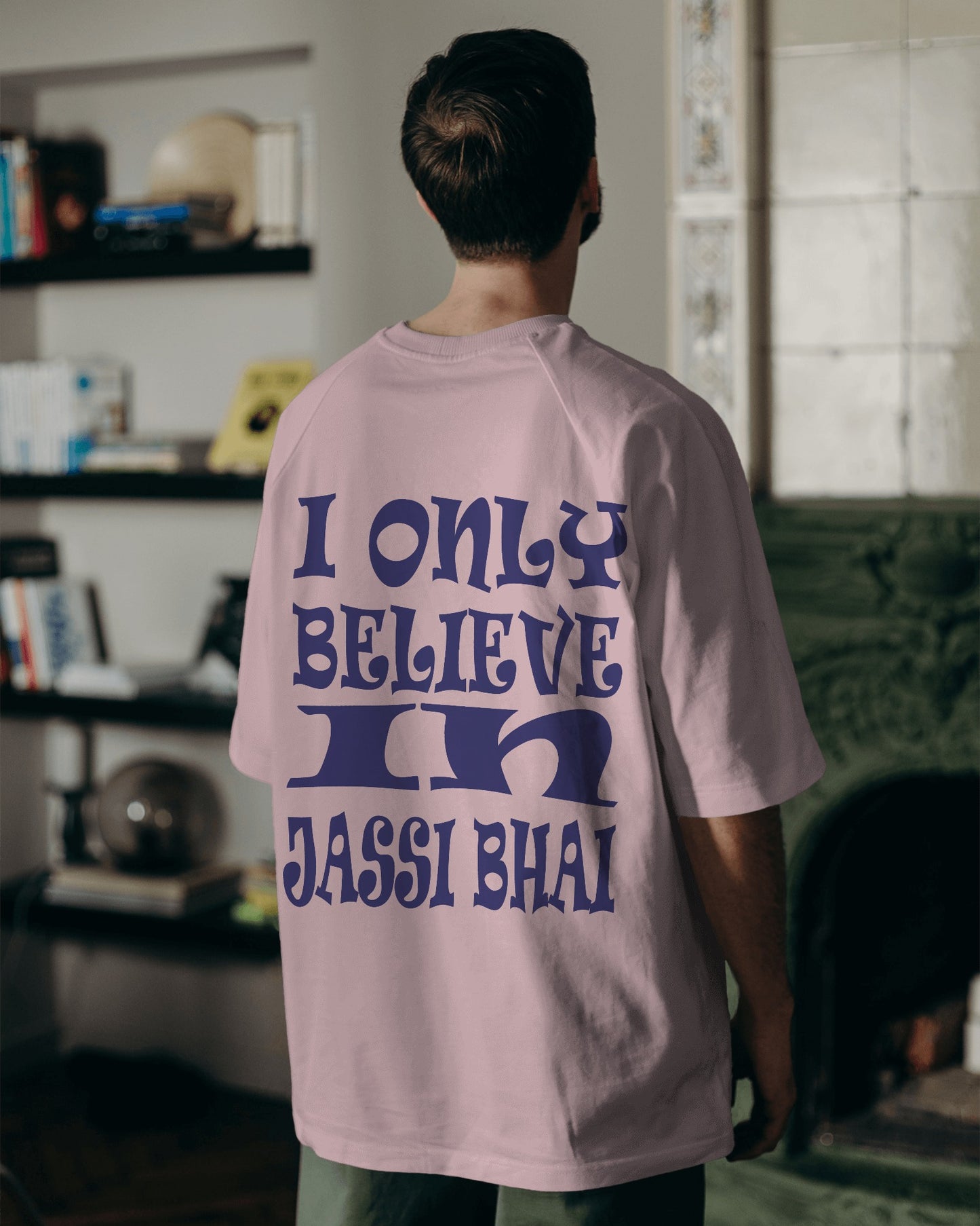 Back view of a male model wearing I only Believe in Jassi Bhai Oversized Tshirt pink