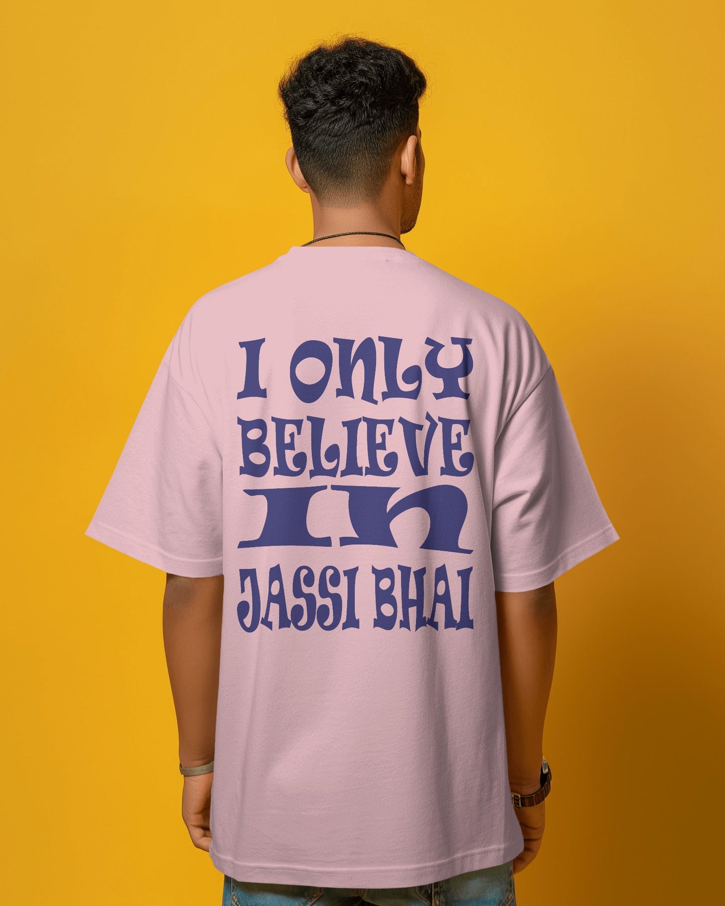 Back view of a male model wearing I only Believe in Jassi Bhai Oversized Tshirt pink