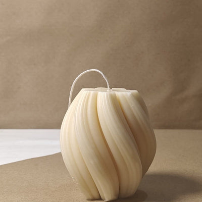 Eco-friendly 4-inch soy wax swirl pillar candle in a natural cream color, offering an elegant and clean burn.