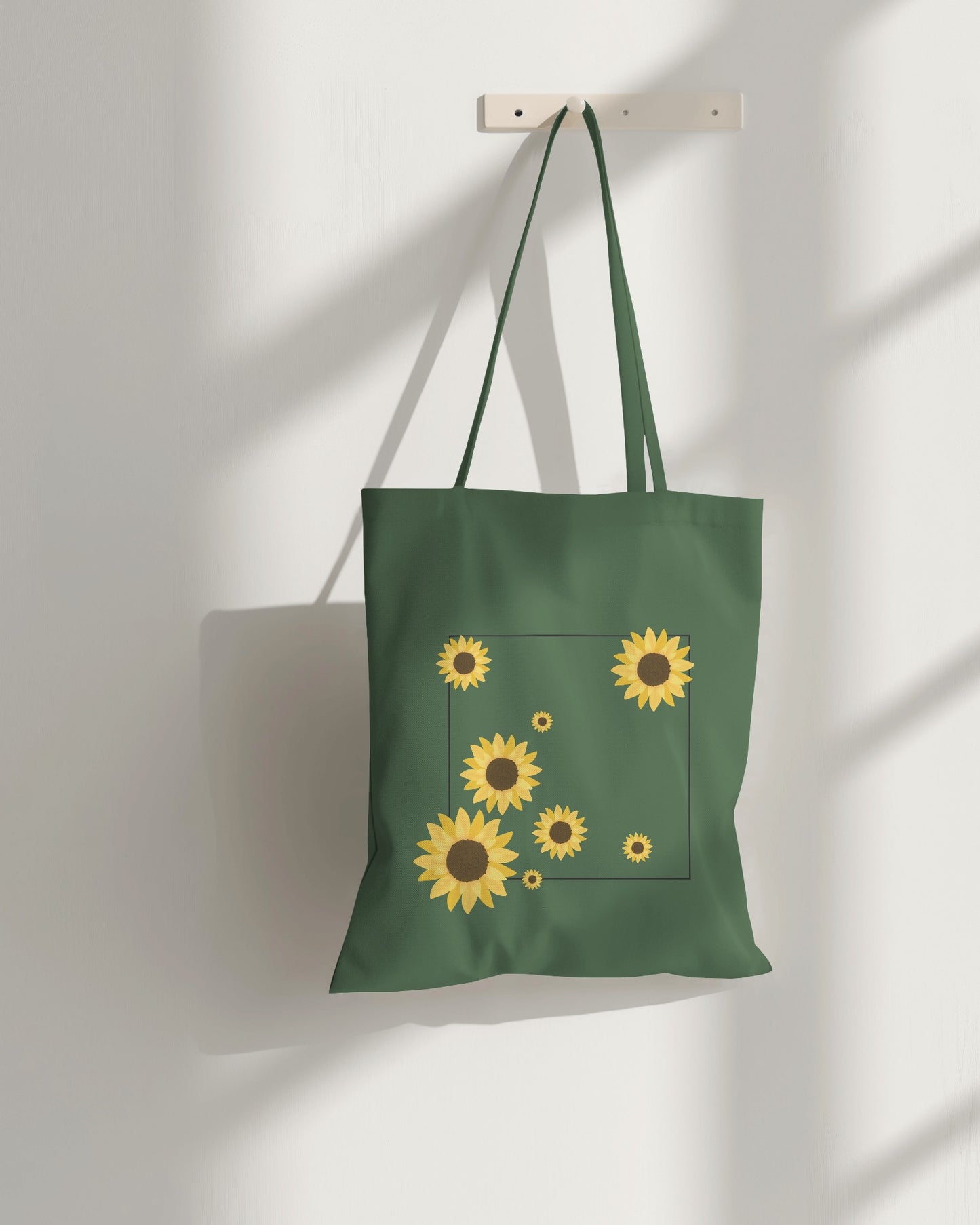a green sunflower tote bag with zipper on a hanger