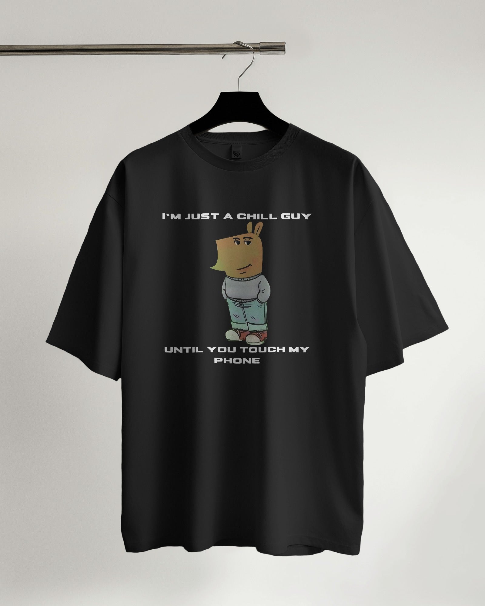 "I’m Just a Chill Guy… Until You Touch My Phone" black tshirt on a hanger with white background