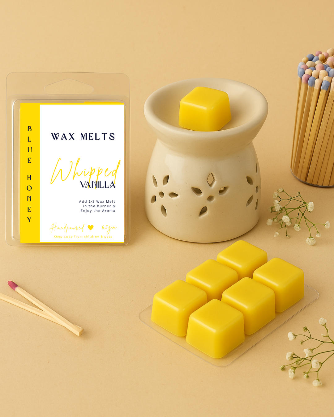 Vanilla wax melt 6 cubes placed with a ceramic oil burner, baby's breath and matchsticks