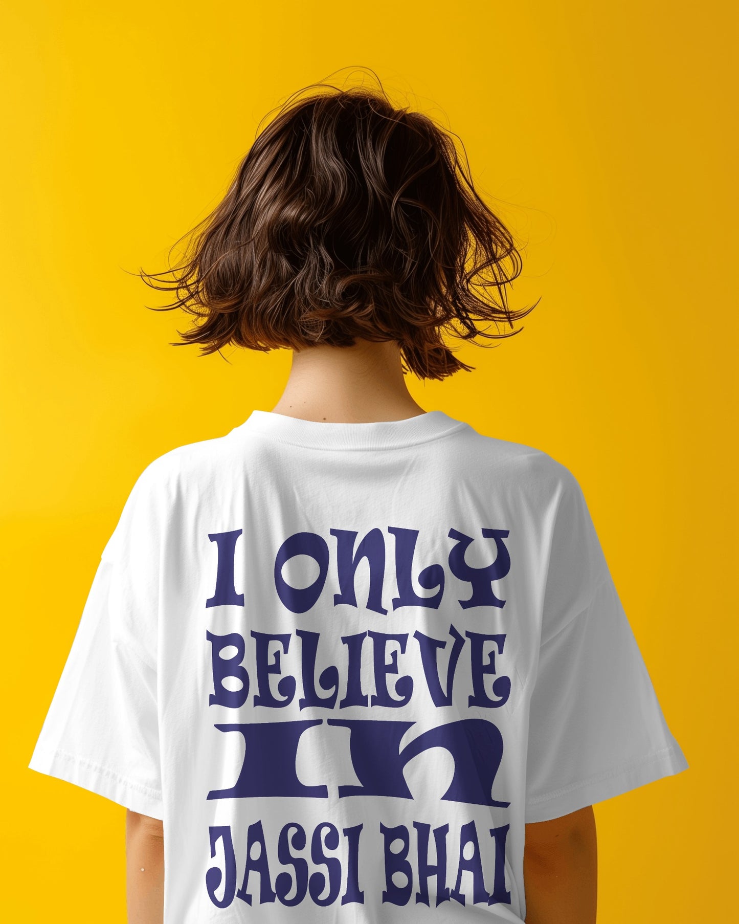 Back view of a female model wearing I only Believe in Jassi Bhai Oversized Tshirt white