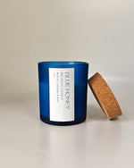 Blue frosted soy wax candle with a cork lid, featuring a white label with 'Blue Honey' text.
