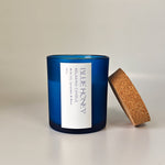 Blue frosted soy wax candle with a cork lid, featuring a white label with 'Blue Honey' text.