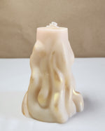 A 4" x 9.5" white 3D wave soy wax pillar candle with gold shimmer, front view.