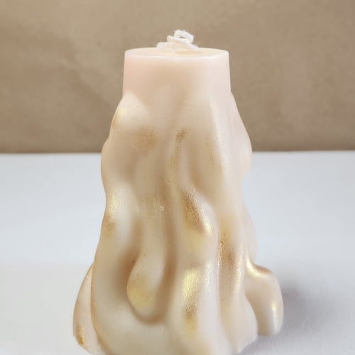 A 4" x 9.5" white 3D wave soy wax pillar candle with gold shimmer, front view.