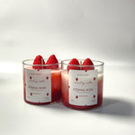 Two Eternal Rose and Strawberry scented soy wax candles in glass jars, front view, with strawberry decorations.