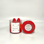 Eternal Rose scented soy wax candle in a glass jar, topped with fresh strawberries.
