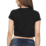 Back view of a black Heart XOXO crop top worn by a woman with blue jeans.