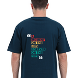 Back view of a unisex oversized navy blue t-shirt with colorful 'A Moment on the Lips, Forever on the Hips' typography.