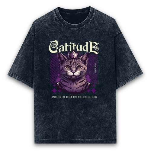 Unisex black oversized acid-wash t-shirt featuring a "Catitude" graphic with a crowned cat and "Exploring the world with nine lives of cool" text.