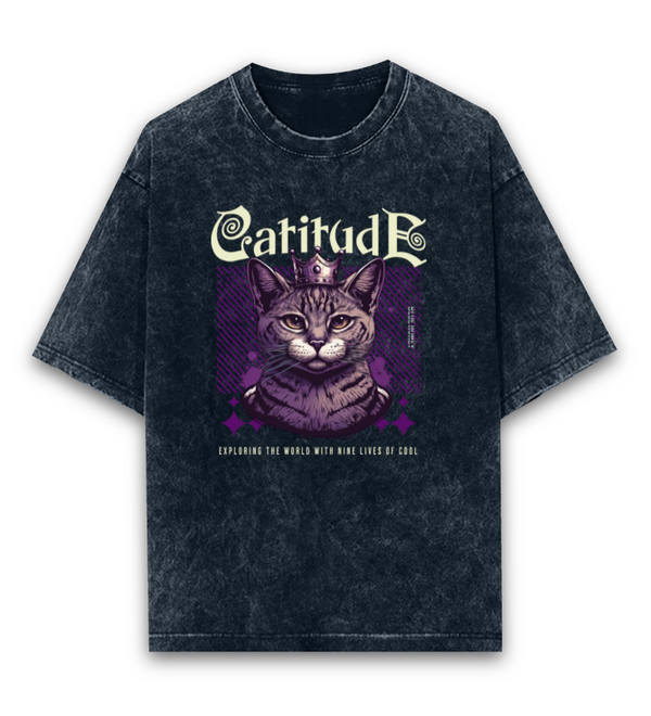 Unisex black oversized acid-wash t-shirt featuring a "Catitude" graphic with a crowned cat and "Exploring the world with nine lives of cool" text.