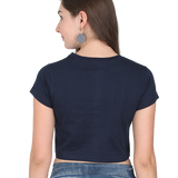 Back view of a dark blue cotton Sunshine and Daisies crop tee worn by a woman with jeans.