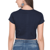 Back view of a black Heart XOXO crop top worn by a woman with blue jeans.