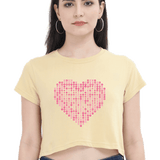 Front view of a light yellow crop top with a pink heart made of X's and O's.