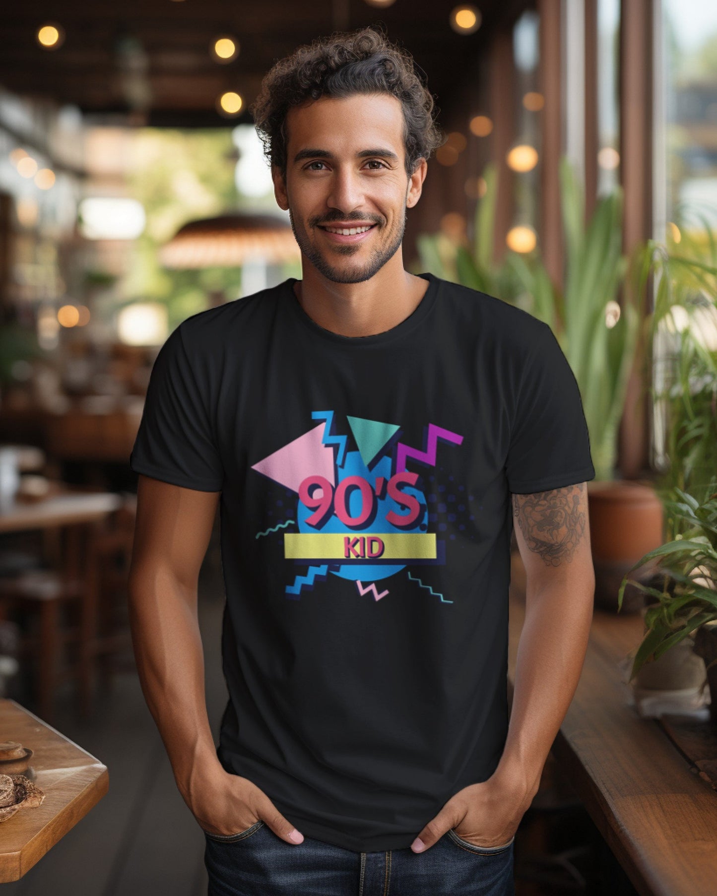 A male model with his hands in his pocket wearing aa '90s Kid' black T-shirt