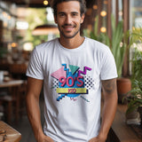 Lifestyle shot of a man wearing a white '90s Kid' graphic t-shirt, smiling at the camera.