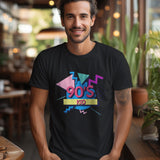 A man wearing a black '90s Kid' t-shirt with a retro graphic design, standing with hands in pockets.