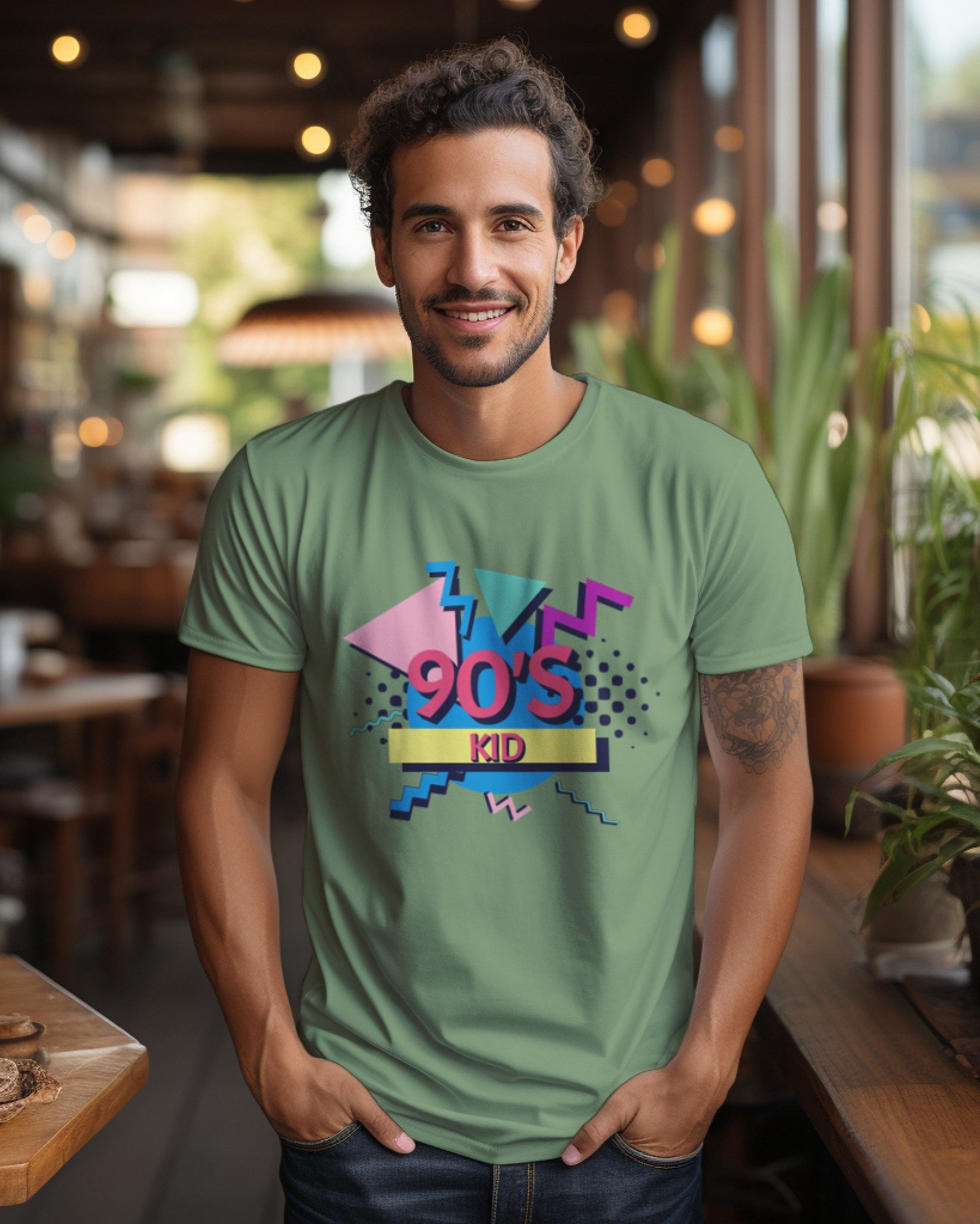 A male model with his hands in his pocket wearing aa '90s Kid' Jade T-shirt