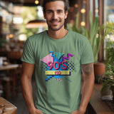 Man wearing a green '90s Kid' t-shirt with a retro graphic design, standing in a cafe.