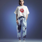 White oversized t-shirt with "Oops! My Bad" lips graphic design, worn by a woman in a studio setting.
