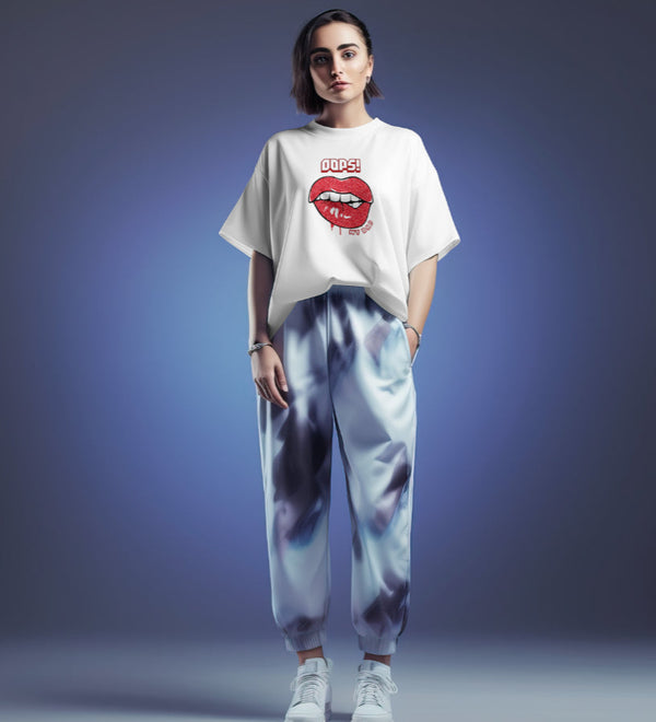 White oversized t-shirt with "Oops! My Bad" lips graphic design, worn by a woman in a studio setting.