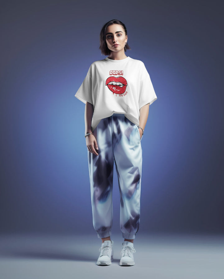 White oversized t-shirt with "Oops! My Bad" lips graphic design, worn by a woman in a studio setting.