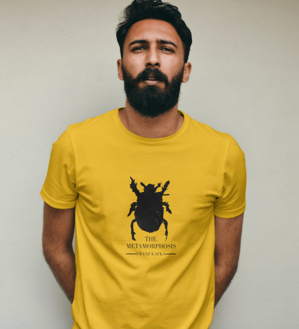 Yellow unisex t-shirt featuring a black silhouette of a beetle and text for 'The Metamorphosis' by Franz Kafka.